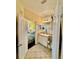 Cozy bathroom with tile flooring, a vanity sink, and an open view to a cheerfully decorated bedroom at 8351 38Th Street E Cir # 302, Sarasota, FL 34243