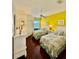 Bright bedroom featuring two twin beds with floral bedding, a ceiling fan, and hardwood floors at 8351 38Th Street E Cir # 302, Sarasota, FL 34243