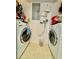 Efficient laundry room with modern washer and dryer units and utility shelving for storage at 8351 38Th Street E Cir # 302, Sarasota, FL 34243
