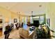 Open-concept living area with tile flooring, comfortable seating, and sliding doors leading to an outdoor balcony at 8351 38Th Street E Cir # 302, Sarasota, FL 34243