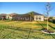Well-maintained backyard featuring a screened patio and lush green lawn, surrounded by partial fencing at 11021 Moonsail Dr, Parrish, FL 34219