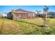 Well-maintained backyard featuring a manicured lawn, a screened patio, and partial fencing at 11021 Moonsail Dr, Parrish, FL 34219