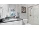 Modern bathroom featuring a sleek vanity with stone countertop, glass-enclosed shower, and neutral color palette at 11021 Moonsail Dr, Parrish, FL 34219