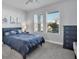 Nautical themed bedroom featuring coastal decor, comfortable furnishings, and natural light through the window at 11021 Moonsail Dr, Parrish, FL 34219