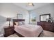 Cozy bedroom featuring wood furnishings, a soft color palette, and a window providing natural light at 11021 Moonsail Dr, Parrish, FL 34219
