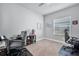 Inviting room with neutral walls and carpet. Includes desks and chairs to create an efficient office space at 11021 Moonsail Dr, Parrish, FL 34219
