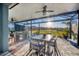 Inviting covered patio with outdoor dining set and picturesque views of the surrounding neighborhood and sunset at 11021 Moonsail Dr, Parrish, FL 34219