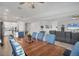 Open concept dining room area with wood table and seating for six adjacent to the kitchen at 11021 Moonsail Dr, Parrish, FL 34219
