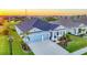 Aerial view of a charming blue two-story home with a well-manicured lawn and a two-car garage at 11021 Moonsail Dr, Parrish, FL 34219