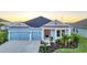 Charming single-Gathering home with a two-car garage and manicured landscaping at sunset at 11021 Moonsail Dr, Parrish, FL 34219