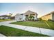 Lovely single-story home featuring lush landscaping and a well-maintained green lawn at 11021 Moonsail Dr, Parrish, FL 34219
