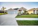 Beautiful single-story home with well-maintained lawn, mature palm trees, and a spacious driveway at 11021 Moonsail Dr, Parrish, FL 34219