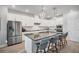 Modern kitchen features an island with seating, stainless steel appliances, and pendant lighting at 11021 Moonsail Dr, Parrish, FL 34219