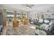 Cozy living room with large windows, a plush rug, comfortable seating, and lots of natural light at 11021 Moonsail Dr, Parrish, FL 34219