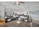 Open-concept living area featuring a large sectional sofa, cozy rug, and an abundance of natural light at 11021 Moonsail Dr, Parrish, FL 34219