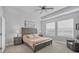 Relaxing main bedroom featuring tray ceiling, neutral tones, and natural light from three windows at 11021 Moonsail Dr, Parrish, FL 34219