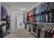 Spacious walk-in closet with custom shelving, rods, and ample storage space for clothing and accessories at 11021 Moonsail Dr, Parrish, FL 34219