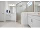 Well-lit bathroom featuring a modern shower, double vanity sinks, and contemporary fixtures at 11522 Trivio Ter, Palmetto, FL 34221