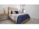 Comfortable bedroom featuring a large bed with stylish bedding, side tables and lamps at 11522 Trivio Ter, Palmetto, FL 34221