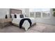 Sunlit bedroom with a plush bed, side tables, and large windows, creating a relaxing ambiance at 11522 Trivio Ter, Palmetto, FL 34221