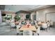 Bright clubhouse dining area featuring tables with seating, contemporary light fixtures and lush outdoor views at 11522 Trivio Ter, Palmetto, FL 34221