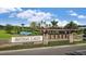Welcome to Artisan Lakes: a beautiful stone entrance sign amidst lush landscaping and serene water features at 11522 Trivio Ter, Palmetto, FL 34221