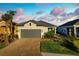 Beautiful single-Gathering home with lush landscaping, a paver driveway, and a welcoming front entrance at 11522 Trivio Ter, Palmetto, FL 34221