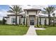 Elegant building exterior with stone accents, mature landscaping, and a welcoming entrance pathway at 11522 Trivio Ter, Palmetto, FL 34221
