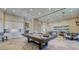 Spacious game room with a pool table, dining area, and ample lighting, perfect for entertainment and social gatherings at 11522 Trivio Ter, Palmetto, FL 34221