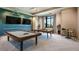 Spacious game room featuring a pool table, ping pong table, modern decor, and large windows for natural light at 11522 Trivio Ter, Palmetto, FL 34221