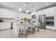 Modern kitchen with stainless steel appliances, white cabinets, and stylish pendant lighting at 11522 Trivio Ter, Palmetto, FL 34221