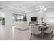Open floor plan with dining area, living room, and large windows creating a bright space at 11522 Trivio Ter, Palmetto, FL 34221
