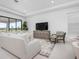 Bright living room featuring neutral decor, large sliding glass doors, and recessed lighting at 11522 Trivio Ter, Palmetto, FL 34221