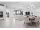 Open floor plan with dining area, living room, and large windows creating a bright space at 11522 Trivio Ter, Palmetto, FL 34221