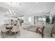 Bright, open-concept living and dining area featuring modern lighting and neutral decor at 11522 Trivio Ter, Palmetto, FL 34221