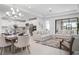 Bright, open-concept living and dining area featuring modern lighting and neutral decor at 11522 Trivio Ter, Palmetto, FL 34221