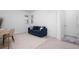 Bright home office featuring a modern desk, blue sofa, and geometric area rug at 11522 Trivio Ter, Palmetto, FL 34221