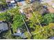 Aerial view of a residential home surrounded by mature trees in a quiet neighborhood at 124 E 119Th Ave, Tampa, FL 33612