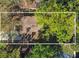 Aerial view of a home with a brown roof surrounded by lush, mature trees and foliage at 124 E 119Th Ave, Tampa, FL 33612
