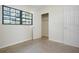Bedroom featuring carpet, closet, window, and a neutral wall color at 124 E 119Th Ave, Tampa, FL 33612