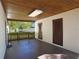 Exterior view of covered patio with wood ceiling, offering access to the backyard and additional storage at 124 E 119Th Ave, Tampa, FL 33612
