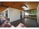 Covered patio with wood ceiling, offering an inviting outdoor living space adjacent to the main house at 124 E 119Th Ave, Tampa, FL 33612