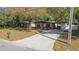 Charming single-story home with a spacious driveway, carport, and a well-manicured front yard at 124 E 119Th Ave, Tampa, FL 33612
