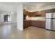 Kitchen featuring stainless steel appliances and brown cabinetry at 124 E 119Th Ave, Tampa, FL 33612