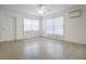 Bright living room featuring two windows, a ceiling fan, and an AC unit at 124 E 119Th Ave, Tampa, FL 33612