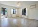 Bright living room featuring neutral walls, large windows, and terrazzo flooring for easy maintenance at 124 E 119Th Ave, Tampa, FL 33612