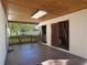Covered outdoor patio with an awning, and a view of the backyard with a white fence at 124 E 119Th Ave, Tampa, FL 33612