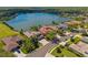 Beautiful waterfront property with stunning lake views, lush landscaping, screened lanai, and a private in-ground pool at 12420 Aster Ave, Bradenton, FL 34212