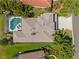 A bird's eye view of a private pool, a well-maintained roof, and lush landscaping in a peaceful backyard at 12420 Aster Ave, Bradenton, FL 34212