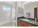 Bright bathroom featuring a shower-tub combo, vanity, and a window at 12420 Aster Ave, Bradenton, FL 34212